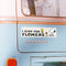white bumper magnet with snoopy and woodstock that says "I STOP FOR FLOWERS' on a blue van