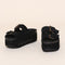 black suede platform slide sandals with oversized buckles and grommets