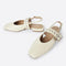 cream slingback flat with large grommet buckle and square toe
