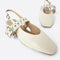 up close of cream slingback flat with large grommet buckle and square toe