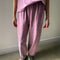 model wearing dusty lilac cotton balloon pants and matching top