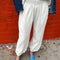 model wearing white cotton balloon pants and matching top