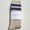 packaged heather oatmeal crew socks with double navy stripes at the top