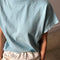 up close of model wearing sky blue cotton tee with slight cap sleeves and white cotton balloon pants