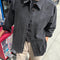 model wearing oversized washed black button down jacket