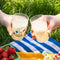 model holding clear pebbled cups with blue cheering woodstock and 'CHEERS' on the reverse side