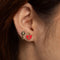 model wearing red heart locket and key stud earrings