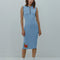model wearing light blue form fitting knit midi dress with button henley front and embroidered clementine details
