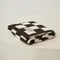 folded cream and espresso brown checkered blanket