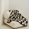 cream and espresso brown checkered blanket on a chair