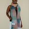 model wearing teal, salmon, green and lilac oversized checker scarf with fringe