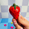 model holding small strawberry shaped incense holder