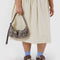 model holding grey snakeskin mini cargo shoulder bag with adjustable strap and two front patch pockets