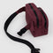 side view of mahogany fanny pack with black trim