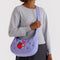 model wearing lavender medium nylon crescent bag with embroidered my melody hugging a strawberry and white flower print as a crossbody