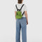 model wearing green juice mini backpack with black straps and trim