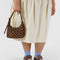 model holding brown leopard mini nylon shoulder bag with adjustable strap
