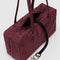 interior black key leash of mahogany rectangular nylon bowler bag with matching zipper and charm clasp