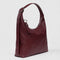 side view of mahogany recycled leather shoulder bag with silver charm clasp