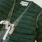 up close of green quilted jacket with white double bow closure