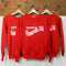 red sweatshirt with white 'WISH YOU WERE HERE IN...PLEASANTVILLE, USA' across the front hanging on a hanger