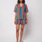 model wearing green, orange and pink vertical stripe terry cloth button front top and matching shorts