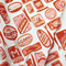 up close of cream tea towel with pink and red sardine can print