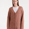 model wearing brown fuzzy textured oversized cardigan