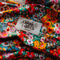 up close of colorful floral twist fabric headband label