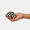 model holding black and off white checkered hair clip
