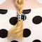 model wearing double sided mini claw with white and black polka dots and black and white stripes