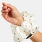 model wearing white silky large scrunchie with all over ant print on their wrist