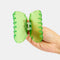 model opening lime green translucent hair claw with wavy edges