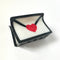 white 'love' letter' hair claw sealed with a red heart