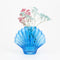 cobalt blue glass seashell vase with dainty flowers inside