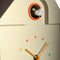 up close of cream house shaped cuckoo clock with rainbow dial and teal trim