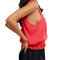 side view of model wearing bright red cotton tank with button front and lace applique detail down the front and hem