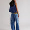 back view of model wearing medium denim barrel jeans with faded sun print design