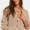 model wearing tan cropped thick knit cardigan