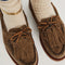 top view of model wearing taupe suede slip on boat shoe with tie top and fringe detail