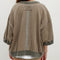 back view of model wearing brown oversized short sleeve sweatshirt with olive green trim