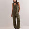 model wearing relaxed fit olive green cotton overalls with side pockets