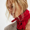 model wearing red knit triangle essential scarf