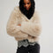 model wearing ivory cropped faux fur jacket with hood