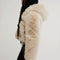 side view of model wearing ivory cropped faux fur jacket with hood