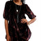 model wearing black velvet tunic with red and burgundy floral print and short sleeve puff sleeves