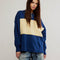 model wearing royal blue and yellow large stripe henley top