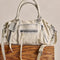 mini washed beige leather purse with several zippered pockets, double handles and crossbody strap