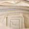 interior of mini washed beige leather purse with several zippered pockets, double handles and crossbody strap