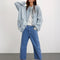 model wearing medium blue denim with a relaxed fit and slight cropped hem